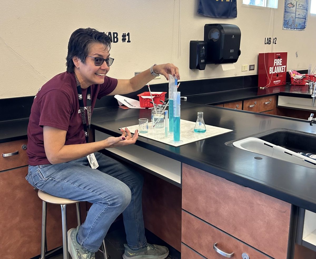 Before school during zero period, Mrs. Maria Powell demonstrates how to use lab equipment in room E8. Photo by Jacob Casetta.