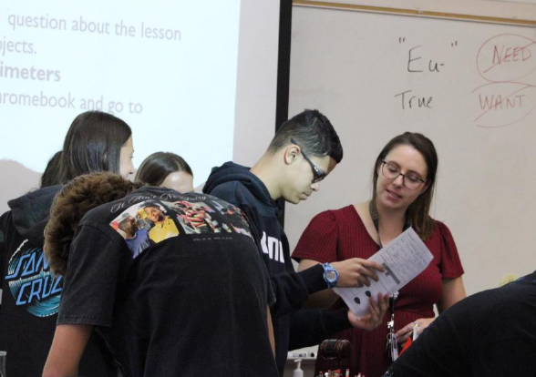 In her classroom, Mrs. Ashley Bailey helps a student during her fourth period biology class. Photo by Sasha Smith.