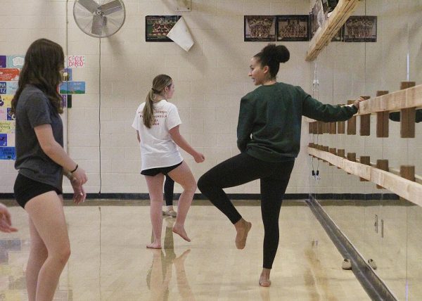 Instructing her Dance I class, Ms. Cierra Askerneese demonstrates a sickle foot. After being a long-term substitute dance teacher at Oakmont, Askerneese got her teaching credential to become a permanent dance instructor. Photo by Natalie Deeble.