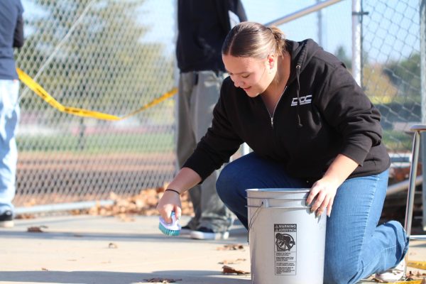 During third period Dec. 5, Abigayle Magennis scrubs fake blood off the ground as a part of the crime scene clean-up process. Photo by Lila Combs