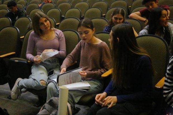 During rehearsal, Jami Redding reads through her script for the spring musical with Brooke Dettner and Audrey Loschiavo. Photo by Leila Alexander.